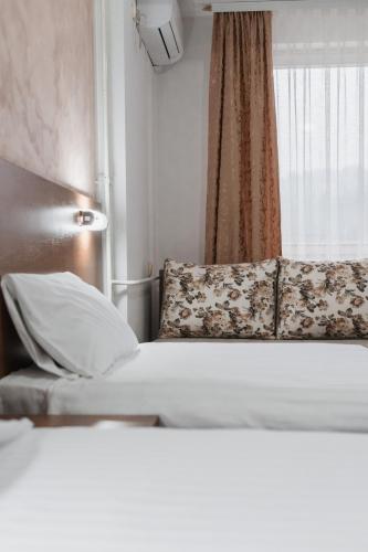 a hotel room with a bed and a window at Hotel Damis in Pale
