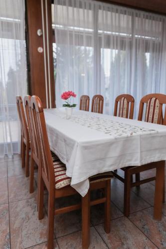 a dining room table with a white table cloth and chairs at Hotel Damis in Pale