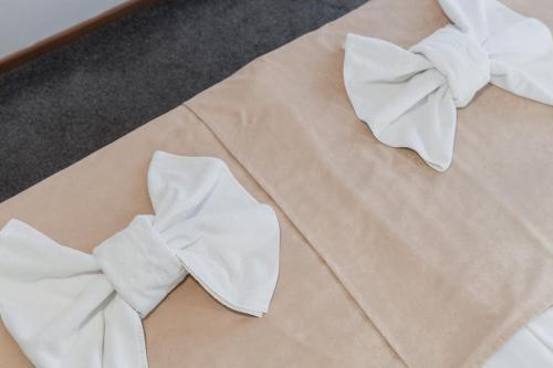 a white shirt with a bow tie on a table at Hotel Damis in Pale
