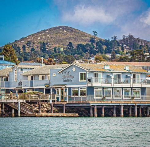 a large house on a dock on the water at Anderson Inn in Morro Bay