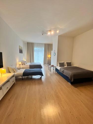 a large room with two beds and a couch at Maria Apartments - Free Parking in Prague