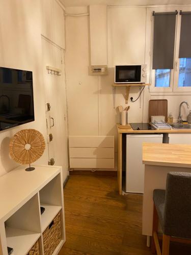 une petite cuisine avec une table et un micro-ondes dans l'établissement Studio cosy centre historique, à Montpellier