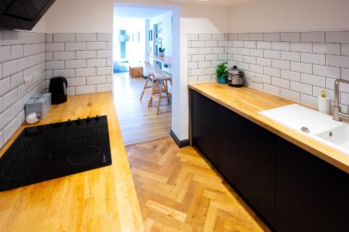 a kitchen with a sink and a counter top at Hidden Retreat with Steam room, KING bed near tube in London