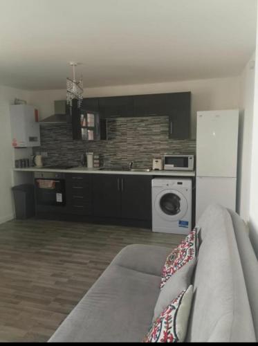 a kitchen with a washing machine and a washer at EG premier lodge in Gillingham