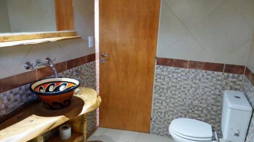 a bathroom with a sink and a toilet at Cabañas La Delfina in Potrero de los Funes