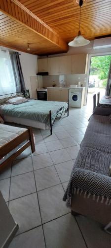 a room with two beds and a kitchen at Home garden and big parking in Tripolis