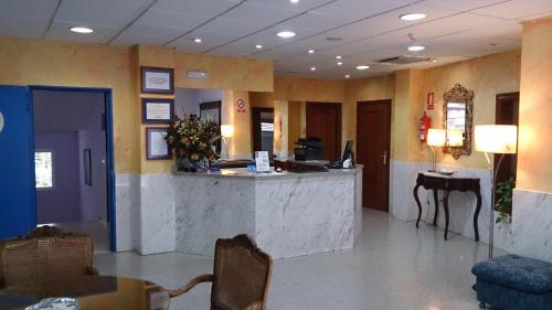 a lobby of a hospital with a reception counter at Hotel Iberia Plaza América in Cáceres