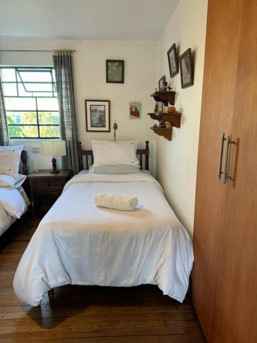 a bedroom with a white bed with a towel on it at Habitación Privada en Mongui in Monguí