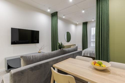a living room with a couch and a table at FORUM apart in Lviv