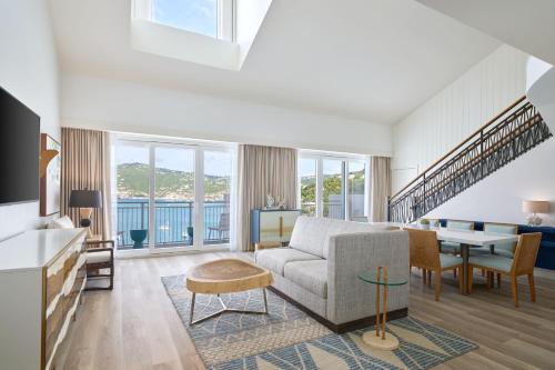 a living room with a couch and a table at The Westin St Thomas Beach Resort & Spa in Frydendal