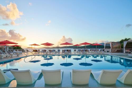 a pool with chairs and umbrellas at a resort at The Westin St Thomas Beach Resort & Spa in Frydendal