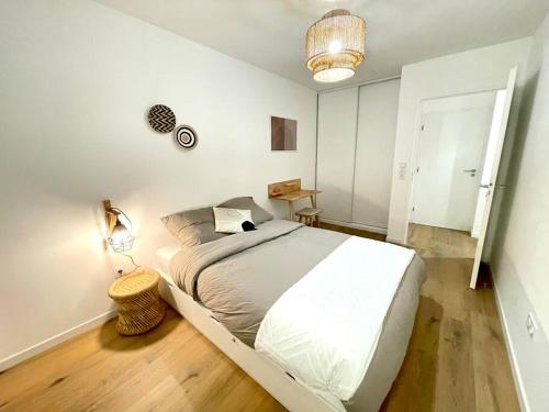 a white bedroom with a large bed in it at Bohemian Lodge Near Paris 8P Metro 14 in Saint-Ouen