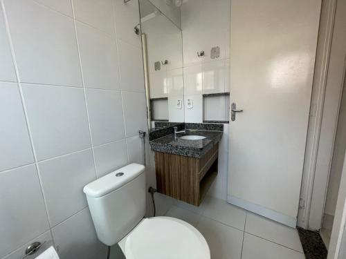 a white bathroom with a toilet and a sink at Caldas Novas - Lacqua diRoma in Caldas Novas