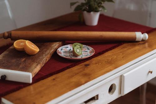 a wooden table with a baseball bat and a plate of food at Il Giardino della Tartaruga in Genova