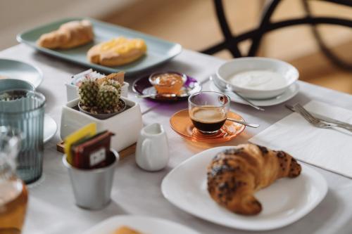 a table with plates of food and drinks on it at Il Giardino della Tartaruga in Genova