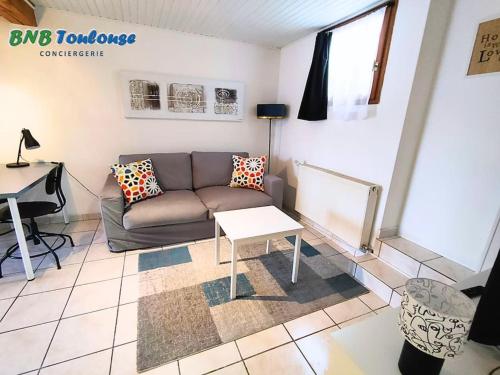 a living room with a couch and a table at ► BNB TOULOUSE ► Le Plaisant Maubec • WiFi • 24/7 in Plaisance-du-Touch