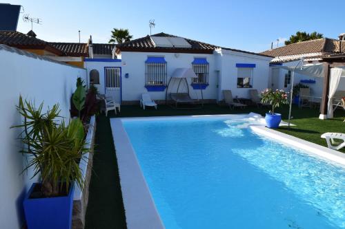 a swimming pool in front of a house at LOS TOCHOS in Chiclana de la Frontera