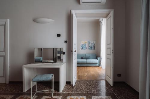 a living room with a blue couch and a table at Il Giardino della Tartaruga in Genova