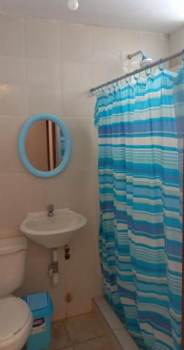 a bathroom with a shower curtain and a sink at Departamento de verano en Camana in Camaná