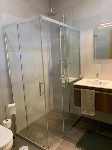 a bathroom with a glass shower and a sink at Quinta do Casal Bystol, Casa 1 in Casal de Loivos
