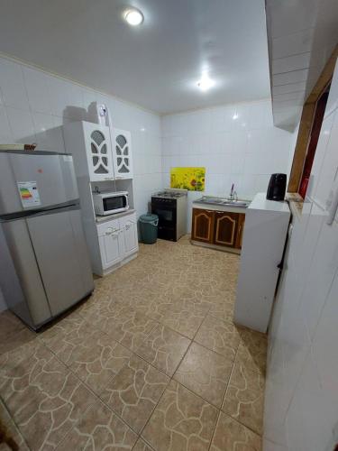 a kitchen with refrigerators and appliances in a room at Noface 11 in Los Vilos