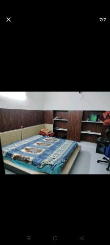 a bed with a blue quilt on top of it at WZ-294 G block, Hari nagar,Jail road,near OM sweets or behind fitness factory gym in New Delhi