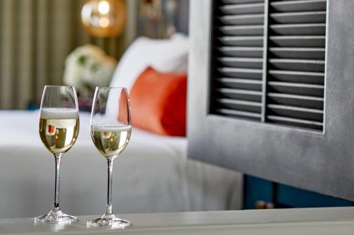two glasses of white wine sitting on a table at Grand Bohemian Orlando, Autograph Collection in Orlando