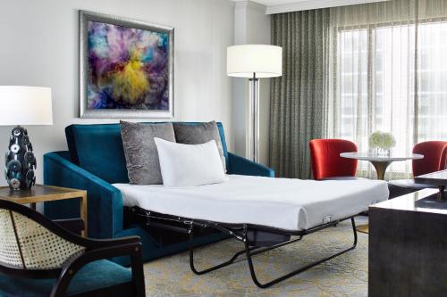 a hotel room with a bed and a couch at Grand Bohemian Orlando, Autograph Collection in Orlando