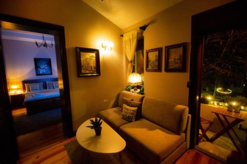 a living room with a couch and a table at Villa Elezi 2 in Korçë