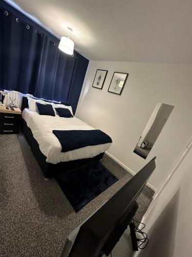 a bedroom with a bed with a blue curtain at One room only Bathroom and toilet shared Located in the city in Newcastle upon Tyne