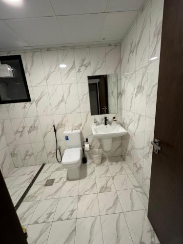 a bathroom with a toilet and a sink at Sharja 904 in Sharjah