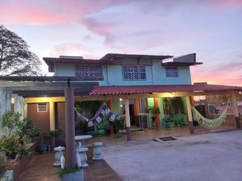 a house with a patio in front of it at Pousada Hotel Araguaia in Aragarças