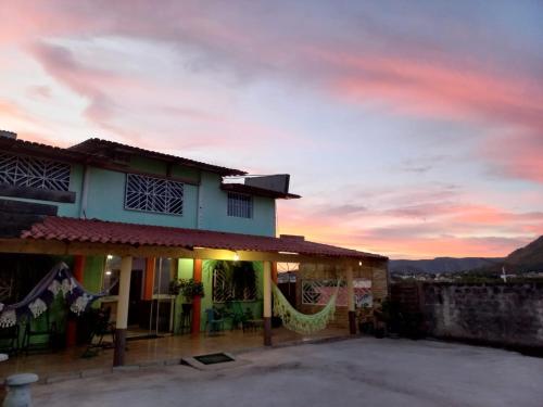 a building with a sunset in the background at Pousada Hotel Araguaia in Aragarças