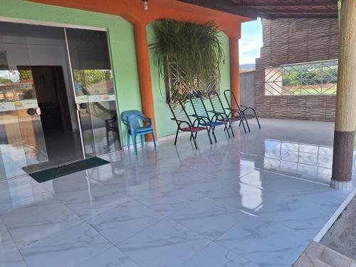 a group of chairs sitting on a patio at Pousada Hotel Araguaia in Aragarças