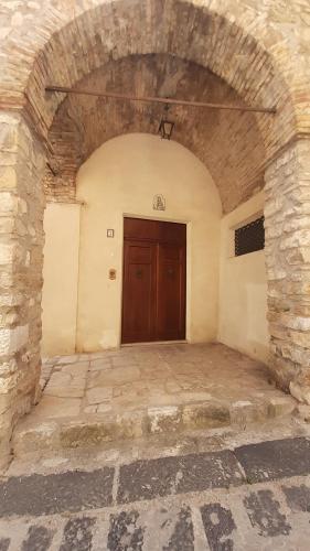 an entrance to a building with a wooden door at Archi di San Giacomo in Cammarata