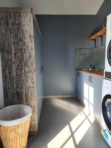 a laundry room with a large wooden door at The Old Dairy on Winkleigh in Exeter