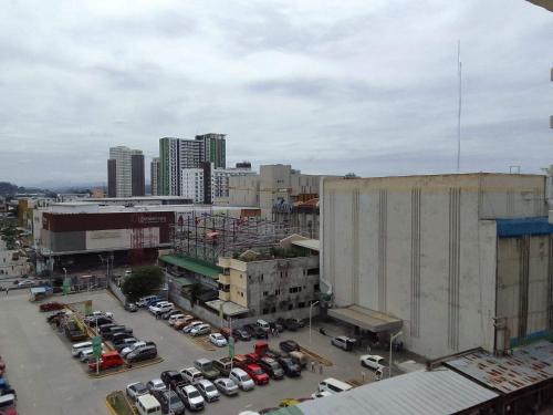 a city with cars parked in a parking lot at Mesaverte Residences T2-8H in Cagayan de Oro