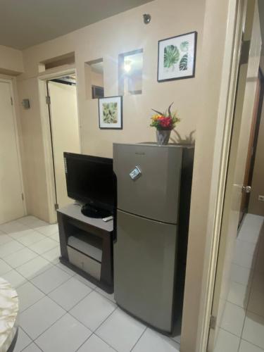 a room with a refrigerator and a television in it at Alkhafy property in Jakarta
