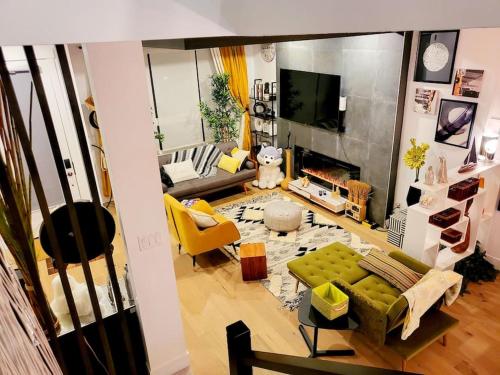a living room with a green couch and a television at Welcome to Happy Place where Cozy Comfort Meets Exquisite Luxury in Edmonton