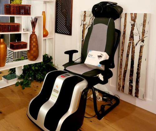 a black and white chair sitting in a room at Welcome to Happy Place where Cozy Comfort Meets Exquisite Luxury in Edmonton