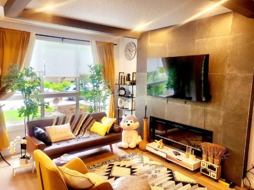 a living room with a couch and a fireplace at Welcome to Happy Place where Cozy Comfort Meets Exquisite Luxury in Edmonton