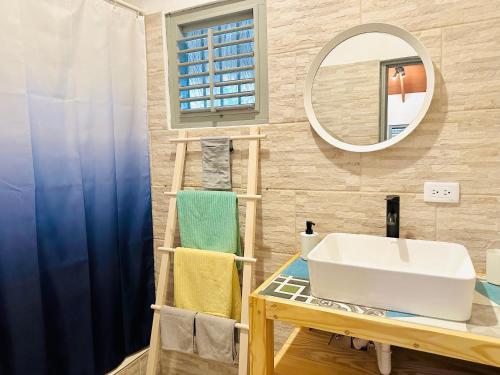 a bathroom with a sink and a mirror at EverGreen Cabarete in Cabarete