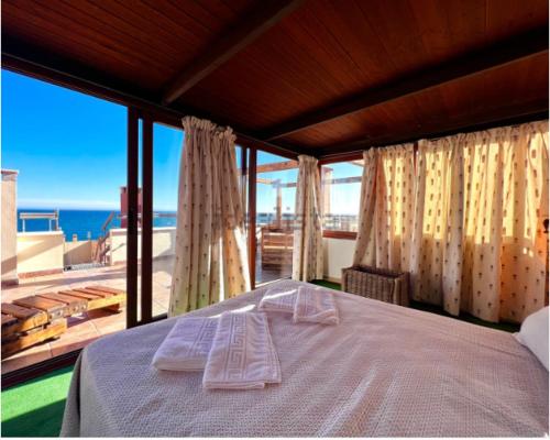 比利亞里科斯的住宿－LA GEODA vivienda vacacional turística 8 personas，一间卧室设有一张床,享有海景