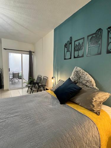 a bedroom with a bed and a view of a patio at Departamentos Yahelik in Cabo San Lucas