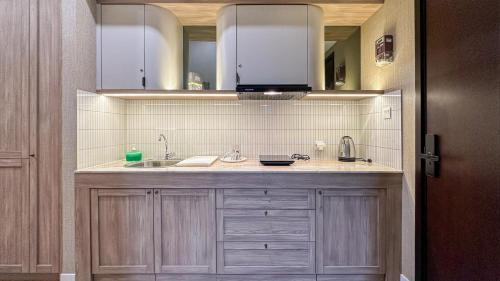 a kitchen with a sink and a counter top at Casa de Parco near ICE BSD AEON Mall - Wabi Sabi in Samporo