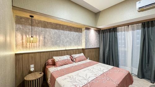 a bedroom with a bed and a window at Casa de Parco near ICE BSD AEON Mall - Wabi Sabi in Samporo