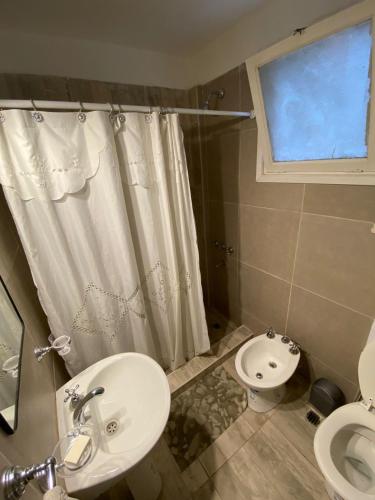 a bathroom with a sink and a toilet and a shower at Depto 2 ambientes Zona Aldrey in Mar del Plata