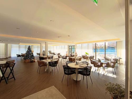 a restaurant with tables and chairs and a christmas tree at GREEN Studio climatisé, vue sur golf proche Montpellier in Montpellier
