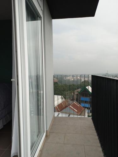 a balcony with a view of a building at Exclusive Apartment, Calzada Roosevelt in Guatemala