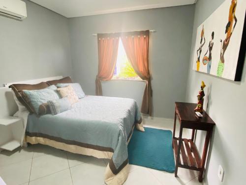 a bedroom with a bed and a window at Villa Paradise in Brazil - Praia de Guaratiba Prado-BA in Prado